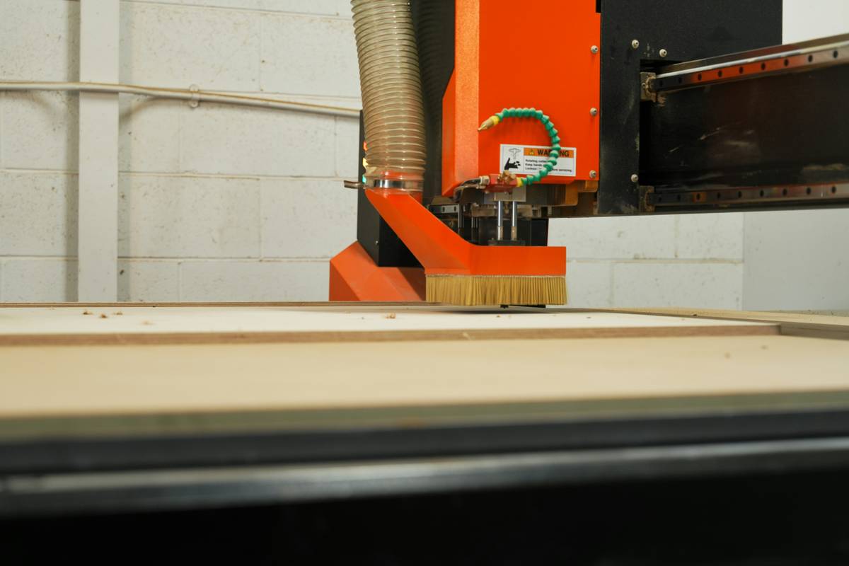 DIY woodworker installing saw blades for woodworking on a table saw with safety gear
