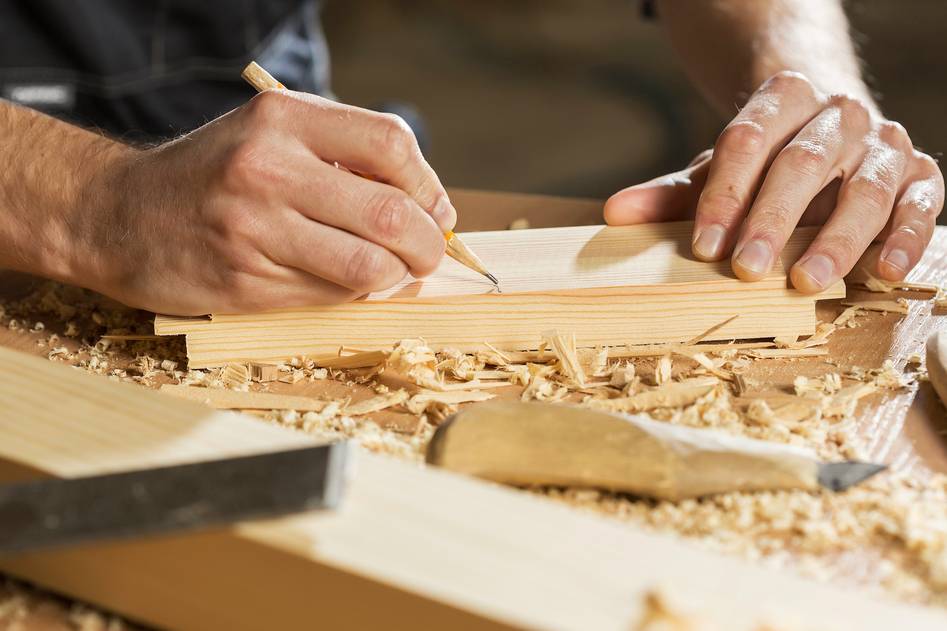 Woodworker using table saw with premium blade