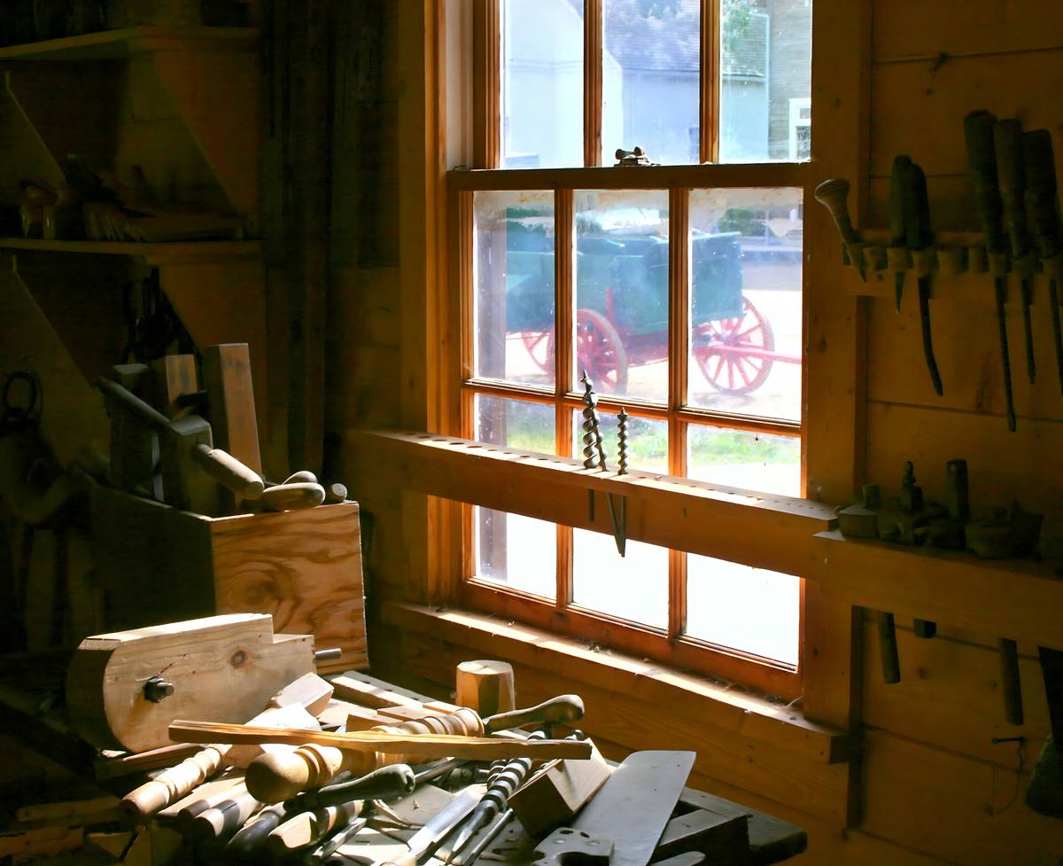 A beginner using a handsaw on a pine board, demonstrating proper technique for saw for woodworking for beginners